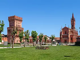 tower,and,catholic,church,under,blue,sky,in,small,town