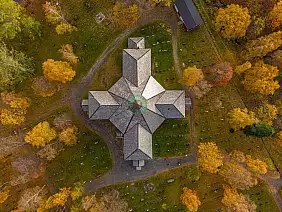 aerial view of a church surrounded by autumn trees in mosjoen, norway