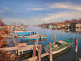 ravenna, emilia romagna, italy: landscape of the wetland in the po delta park with boats...