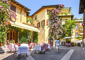 turistipercaso Buildings in Gardone Riviera covered by large flowering climbing plant