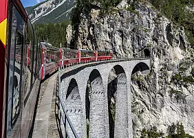 turistipercaso Bernina Express train on the famous Landwasser Viaduct near Filisur and Davos