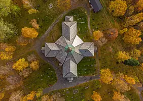 turistipercaso Aerial view of a church surrounded by autumn trees in Mosjoen, Norway